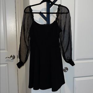 Black dress with sheer sleeves.